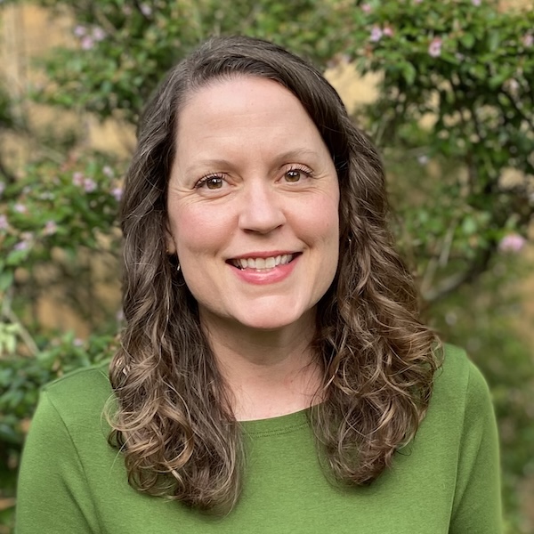 Libby Bawcombe outdoors with greenery.